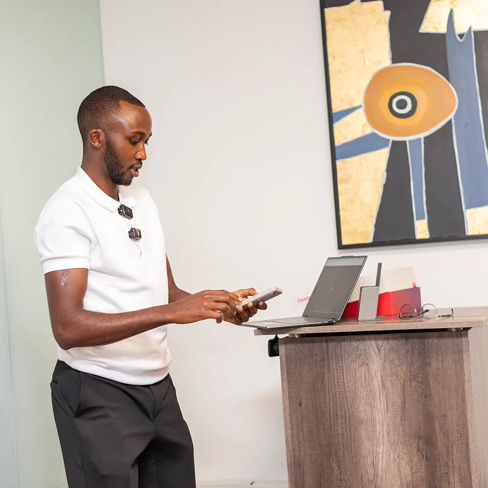 Elvis W. demonstrating digital skills with a smartphone during a training session